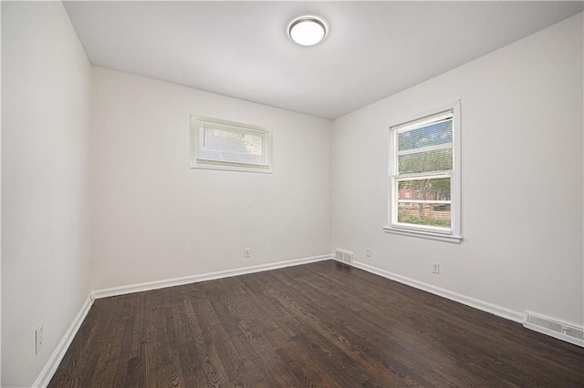 3525-3527 Bell St, Kansas City, MO 64111 - spare room with baseboards, dark wood-type flooring, and visible vents