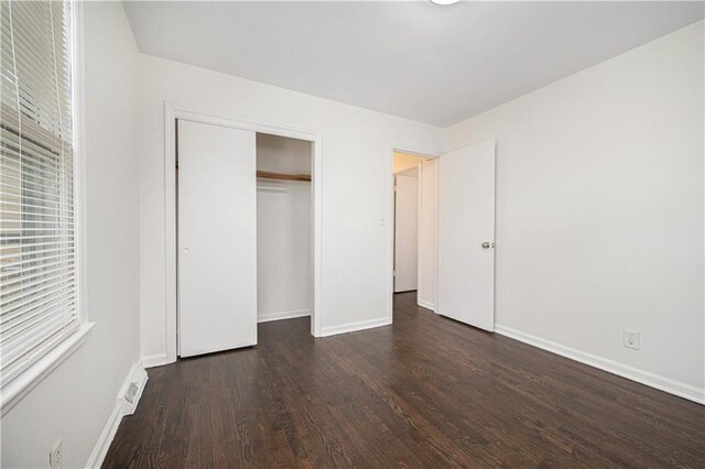 3525-3527 Bell St, Kansas City, MO 64111 - unfurnished bedroom featuring baseboards, visible vents, and wood finished floors