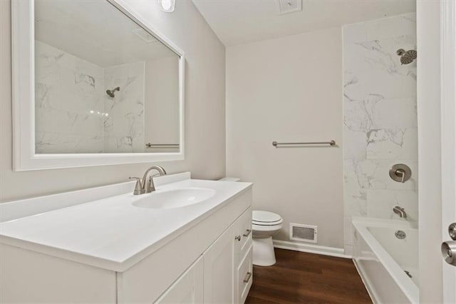 full bathroom with visible vents, vanity, wood finished floors, toilet, and baseboards