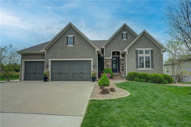 view of front of house featuring a garage, a front lawn, stone siding, stucco siding, and driveway