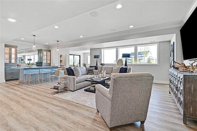 12605 W 170th St, Overland Park, KS 66221 - living area with ornamental molding, baseboards, plenty of natural light, light wood-type flooring, and a textured ceiling