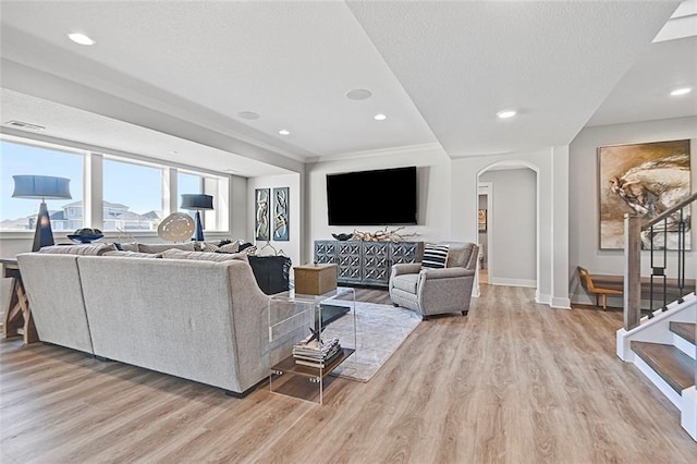 12605 W 170th St, Overland Park, KS 66221 - living area with arched walkways, light wood-type flooring, baseboards, recessed lighting, and stairway
