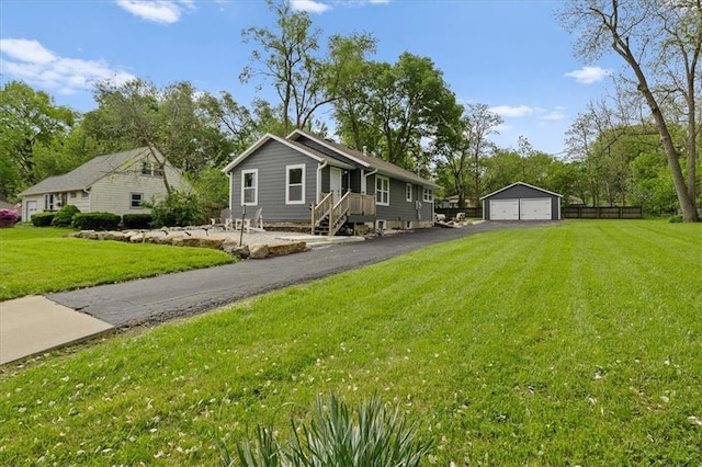 view of front facade with an outdoor structure, a front lawn, and a detached garage