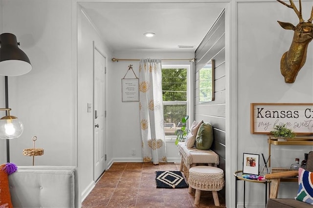 interior space featuring visible vents and crown molding