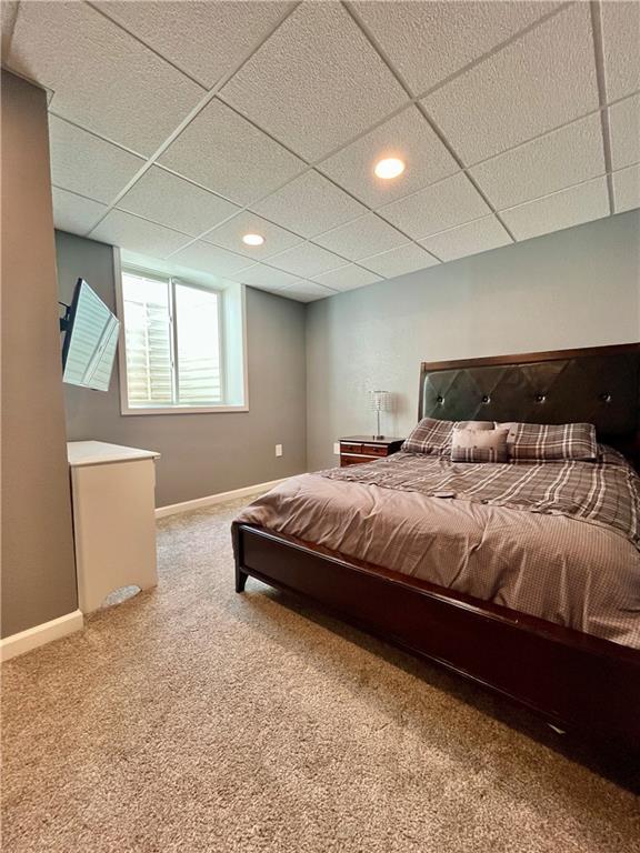 bedroom featuring baseboards, carpet flooring, recessed lighting, and a paneled ceiling