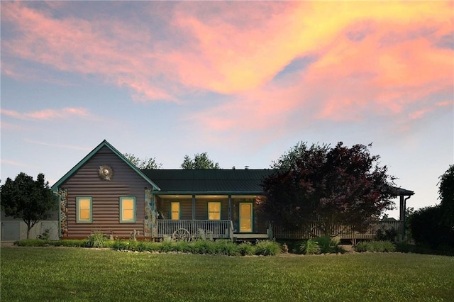 36404 E County Line Rd, Lone Jack, MO 64070 - view of front of property with covered porch, a front yard, and log siding