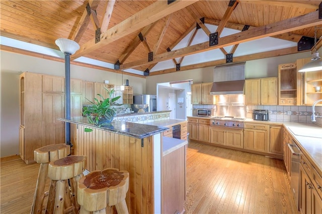 kitchen featuring a large island, appliances with stainless steel finishes, open shelves, light wood-style flooring, and light brown cabinets