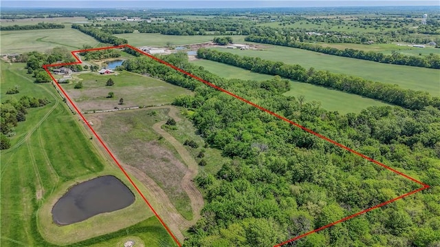 aerial view of sparsely populated area featuring property boundaries highlighted and a nearby body of water