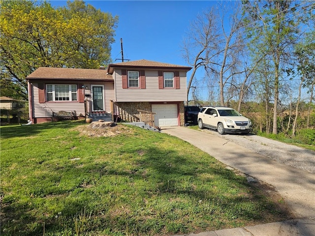 8212 NE 51st St, Kansas City, MO 64119 - tri-level home with an attached garage, concrete driveway, and a front yard