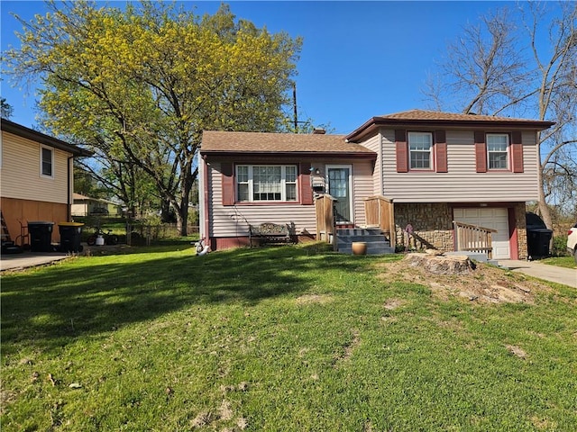 8212 NE 51st St, Kansas City, MO 64119 - tri-level home featuring concrete driveway, a front yard, and a garage
