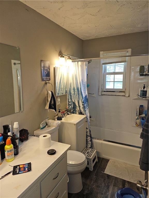 8212 NE 51st St, Kansas City, MO 64119 - full bath featuring vanity, toilet, a textured ceiling, wood finished floors, and shower / tub combo