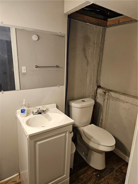 8212 NE 51st St, Kansas City, MO 64119 - bathroom with vanity, toilet, and wood finished floors