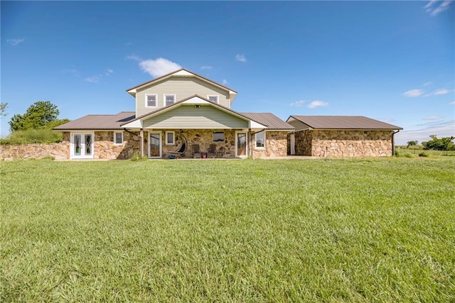 14779 SE Virginia Rd, Kincaid, KS 66039 - back of property featuring stone siding, a lawn, and french doors