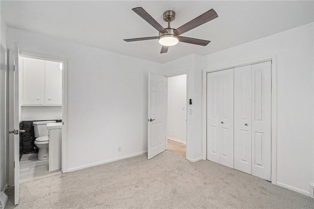 321 22nd Street Ter, Blue Springs, MO 64015 - unfurnished bedroom featuring a closet, baseboards, light colored carpet, connected bathroom, and a ceiling fan