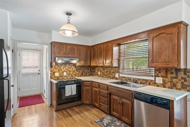 4071 SW Royale Ct, Lees Summit, MO 64082 - kitchen with stainless steel appliances, under cabinet range hood, light wood-style floors, and light countertops