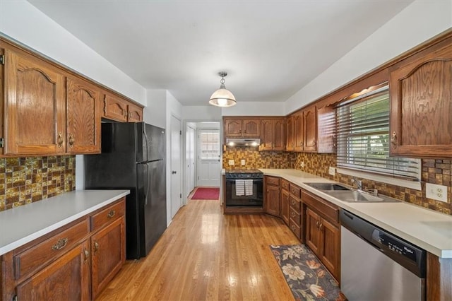 4071 SW Royale Ct, Lees Summit, MO 64082 - kitchen with dishwasher, electric stove, under cabinet range hood, freestanding refrigerator, and backsplash