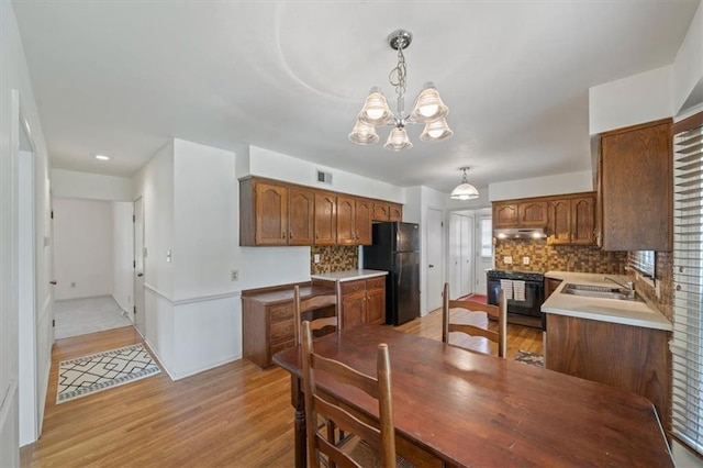 4071 SW Royale Ct, Lees Summit, MO 64082 - dining room featuring a chandelier and light wood finished floors