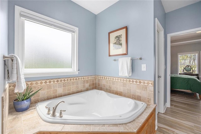 full bath featuring ensuite bathroom and a bath