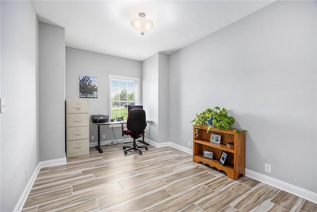 office area with baseboards and wood finished floors