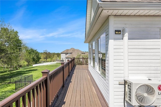 wooden deck with a yard and ac unit