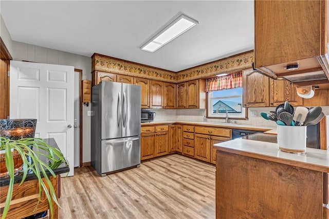 19890 State Highway C, Pattonsburg, MO 64670 - kitchen featuring freestanding refrigerator, brown cabinetry, light wood finished floors, and light countertops