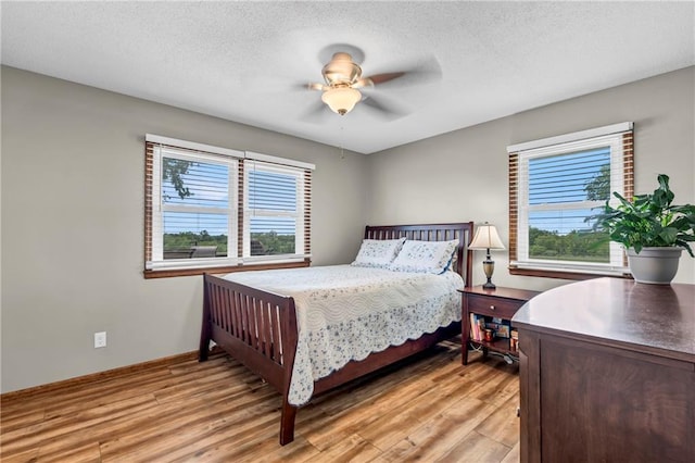 19890 State Highway C, Pattonsburg, MO 64670 - bedroom with light wood-style flooring, a textured ceiling, baseboards, and ceiling fan