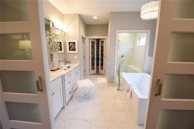 9410 Deer Run St, Lenexa, KS 66220 - full bathroom with marble finish floors, a soaking tub, double vanity, a walk in shower, and recessed lighting