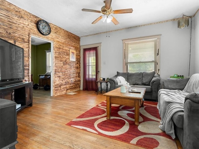 living area featuring light wood-style floors and a ceiling fan