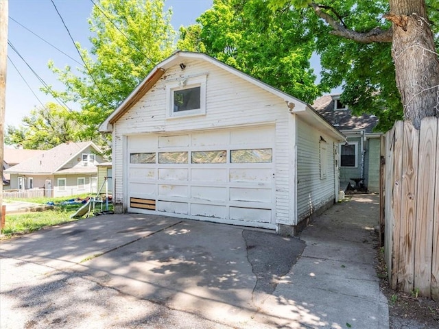 detached garage featuring fence
