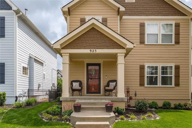925 SW Ovation Dr, Lees Summit, MO 64081 - view of front facade with covered porch, fence, and a front lawn