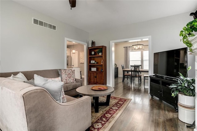 925 SW Ovation Dr, Lees Summit, MO 64081 - living area with visible vents, dark wood-style flooring, and a chandelier