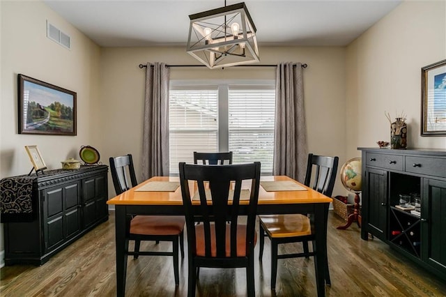 925 SW Ovation Dr, Lees Summit, MO 64081 - dining space featuring visible vents, dark wood-type flooring, and a notable chandelier