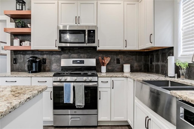 925 SW Ovation Dr, Lees Summit, MO 64081 - kitchen featuring white cabinets, open shelves, stainless steel appliances, and backsplash
