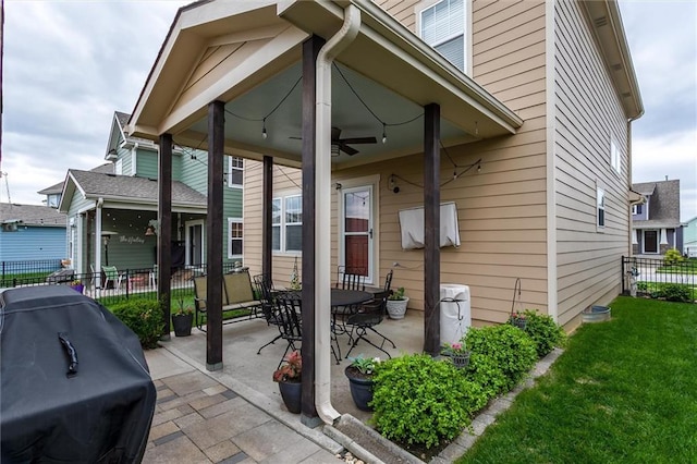 925 SW Ovation Dr, Lees Summit, MO 64081 - property entrance with fence, ceiling fan, a yard, and a patio area