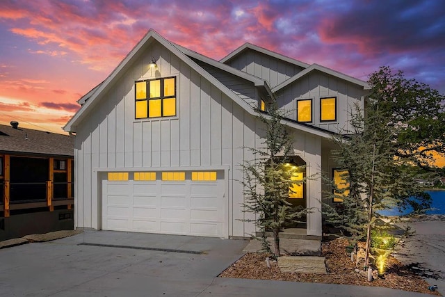 view of front of house with board and batten siding, driveway, and a garage