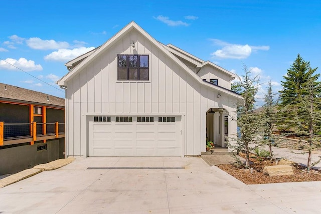 view of front of home with board and batten siding, an attached garage, and driveway