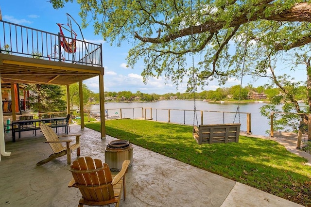 view of yard featuring a water view and a patio