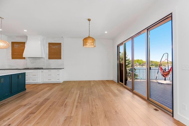 unfurnished dining area with light wood-type flooring, recessed lighting, baseboards, and visible vents