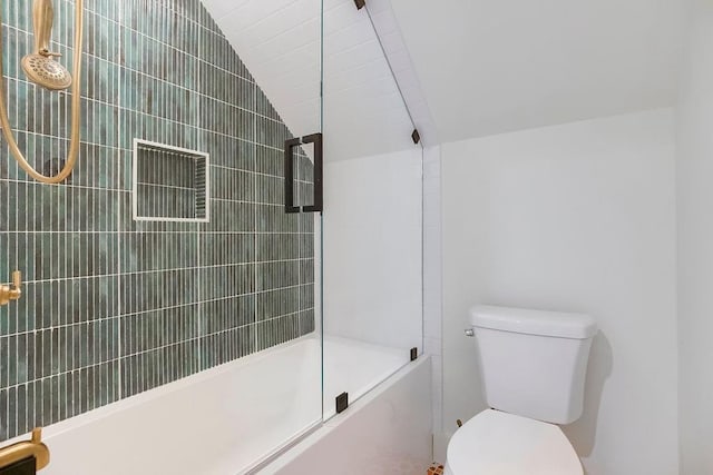 bathroom featuring toilet, enclosed tub / shower combo, and lofted ceiling