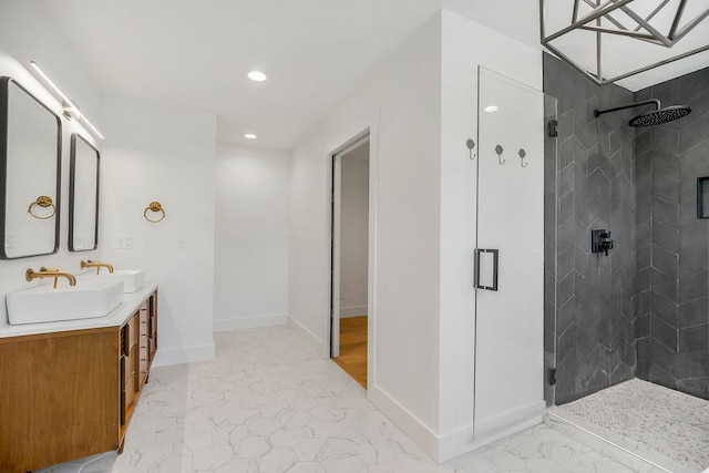 bathroom with baseboards, a sink, marble finish floor, and a stall shower