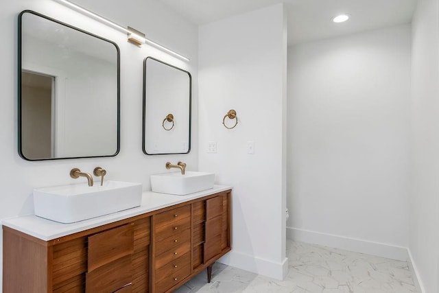 bathroom with recessed lighting, baseboards, a sink, and marble finish floor
