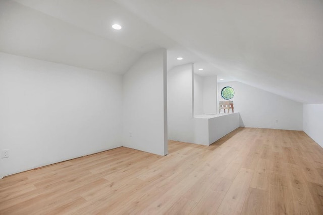 bonus room with vaulted ceiling, recessed lighting, and wood finished floors