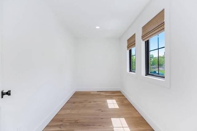 empty room featuring baseboards, recessed lighting, and light wood-style flooring