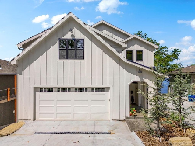 modern farmhouse style home with concrete driveway, board and batten siding, and a garage