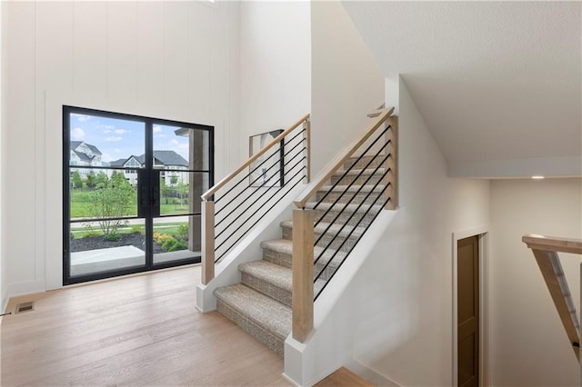 10675 W 142nd Ter, Overland Park, KS 66221 - stairs featuring high vaulted ceiling and wood finished floors