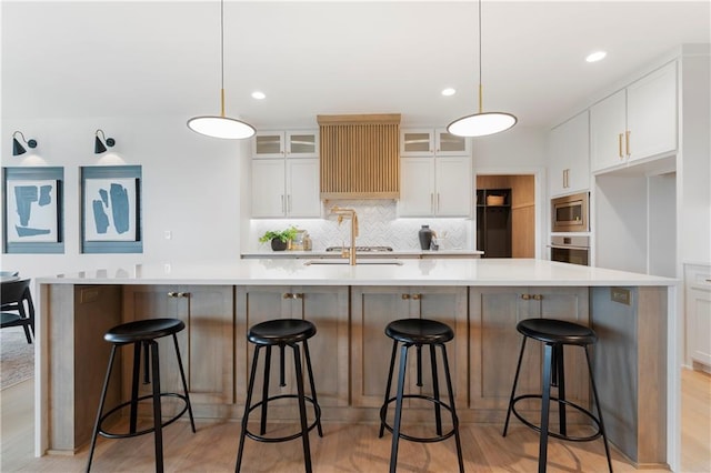 10675 W 142nd Ter, Overland Park, KS 66221 - kitchen featuring stainless steel appliances, decorative backsplash, white cabinets, glass insert cabinets, and light countertops