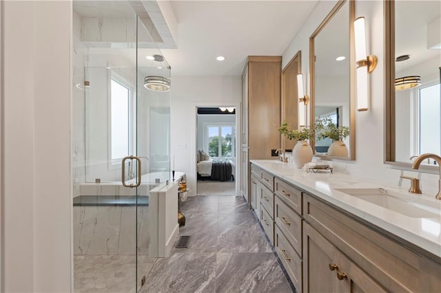 10675 W 142nd Ter, Overland Park, KS 66221 - bathroom featuring double vanity, a stall shower, marble tiled flooring, connected bathroom, and recessed lighting