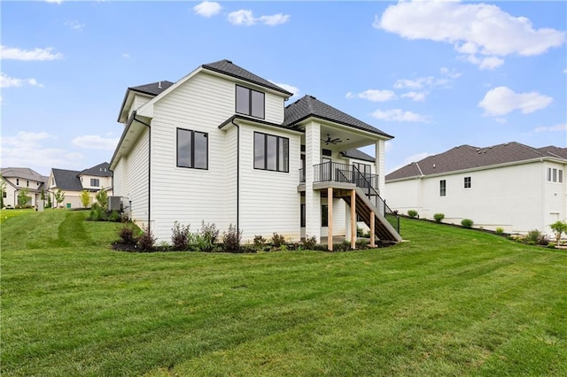 10675 W 142nd Ter, Overland Park, KS 66221 - back of property featuring a ceiling fan, stairway, a yard, and a deck