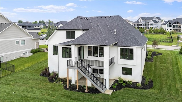 10675 W 142nd Ter, Overland Park, KS 66221 - back of property featuring a shingled roof, a residential view, stairs, a yard, and a wooden deck