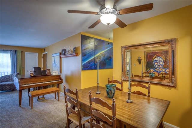 carpeted dining area featuring baseboards and ceiling fan